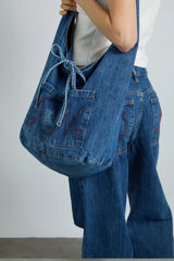 denim sling bag with pocket detail